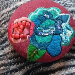 Small mirror with embellished padded back.